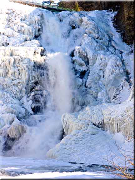 Natural ice sculpture building up on Ithaca Falls in winter.
